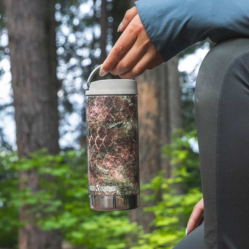 12oz-tkwide-with-twist-cap-mossy-oak-h8 12oz_tumbler_mossyoak_rainbowtrout_hand_closeup_square.jpg