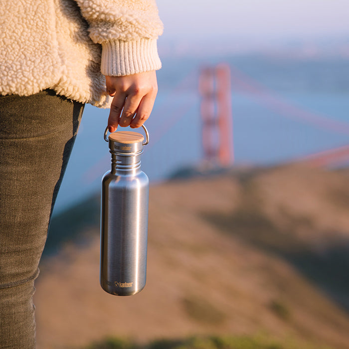 27oz-reflect-with-bamboo-cap-g2 K27SSLRF-BS-BAMBOO_reflect_bottle_bridge_lifestyle.jpg