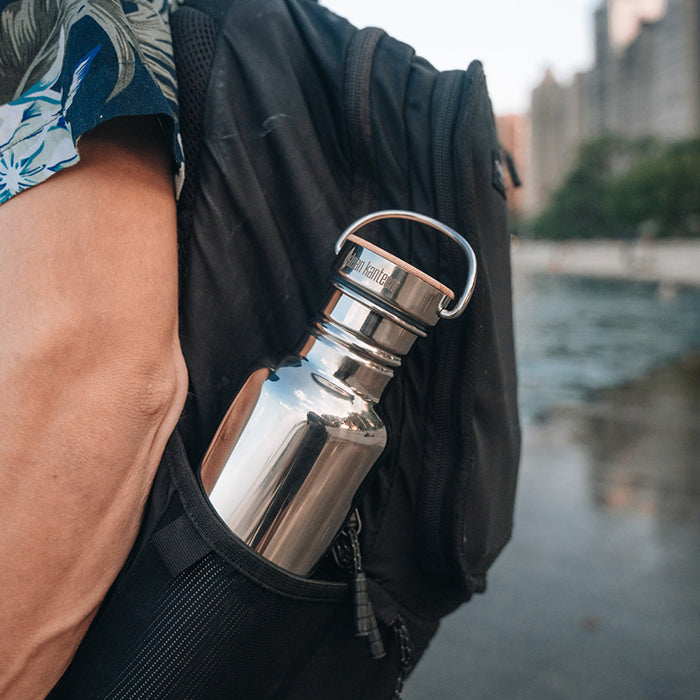 27oz-reflect-with-bamboo-cap-g2 K27SSLRF-MS-BAMBOO_reflect-bottle_backpack_lifestyle.jpg